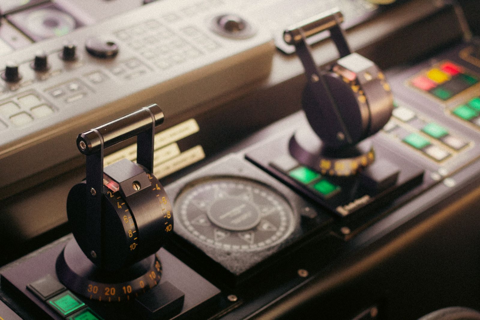 Engine throttles and a compass on a ship control console, the speed inputs for an ocean miles calculator