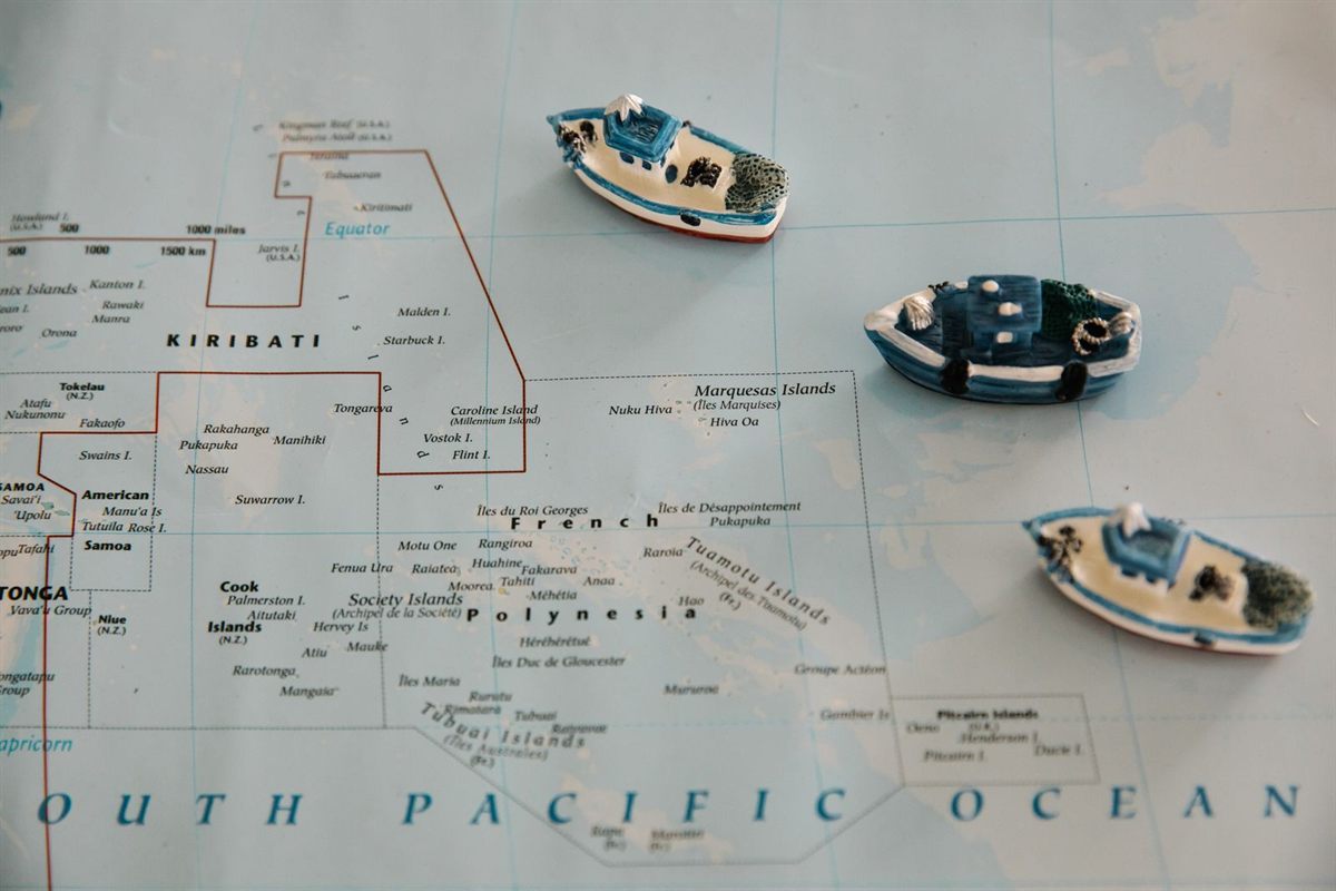 Toy boats placed on a map of the South Pacific Ocean